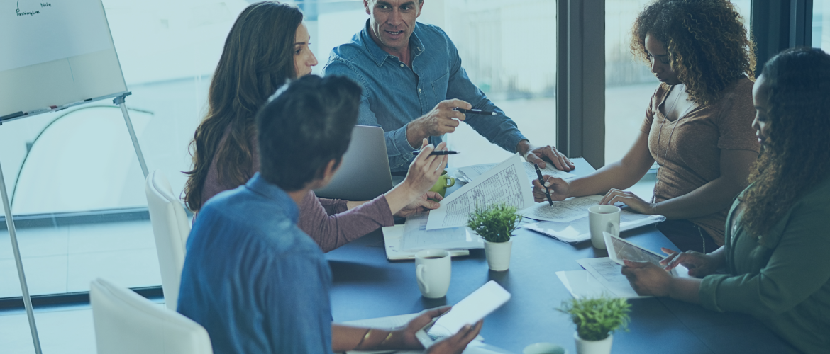 team in an office around a boardroom table.