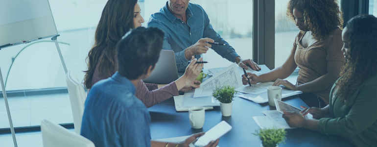 team in an office around a boardroom table.