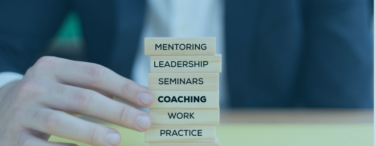 male hand holding bricks saying mentoring coaching